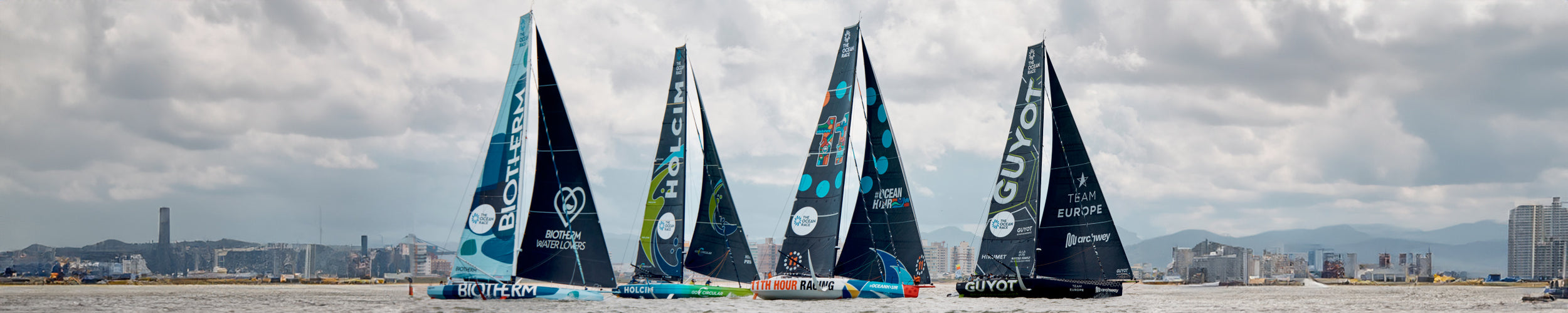 Wide image of team Biotherm, Holcim, 11th Hour Racing and Guyot boats at sea during the Ocean Race 2023